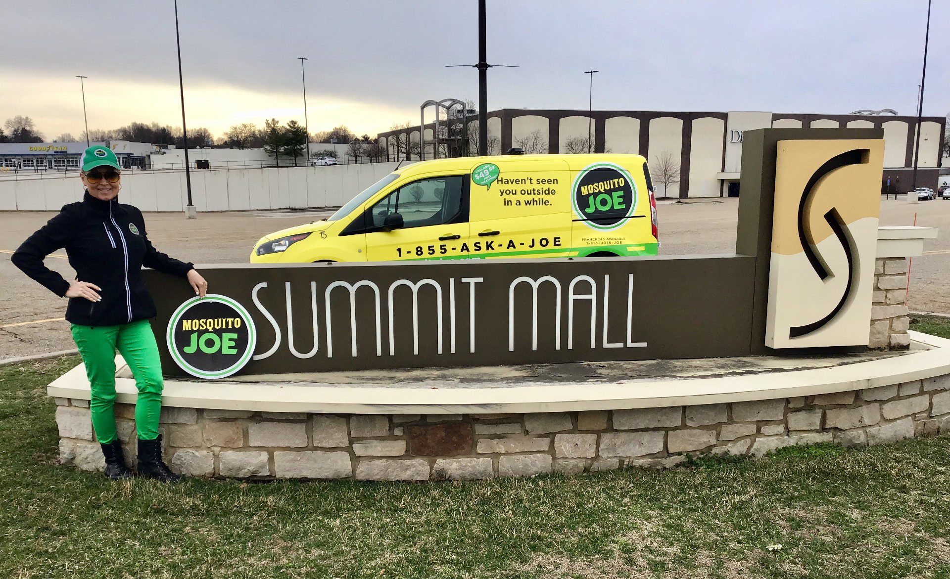 Mosquito Joe technician and service van pose beside the Summit Mall Sign in Ohio.