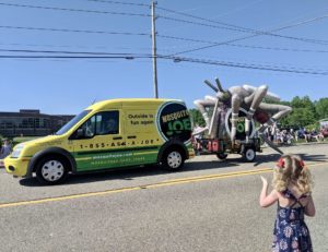 Mosquito Joe of Akron yellow and green turned into a parade float with a giant inflatable mosquito at the 2022 City of Green Memorial Day Parade!